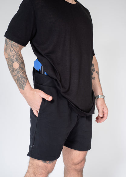 Person wearing a black t-shirt and shorts on a white background